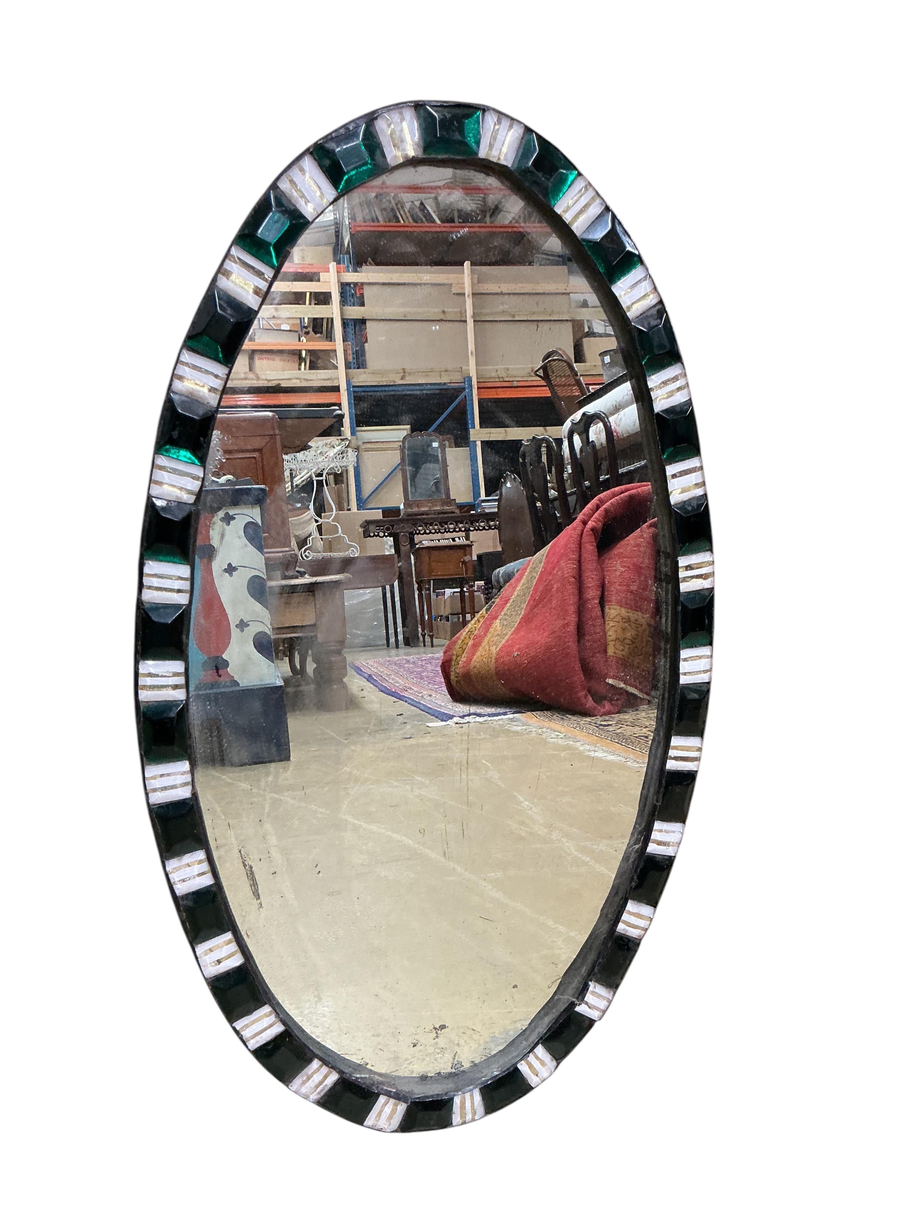 An oval Irish style wall mirror, width 37cm, height 65cm